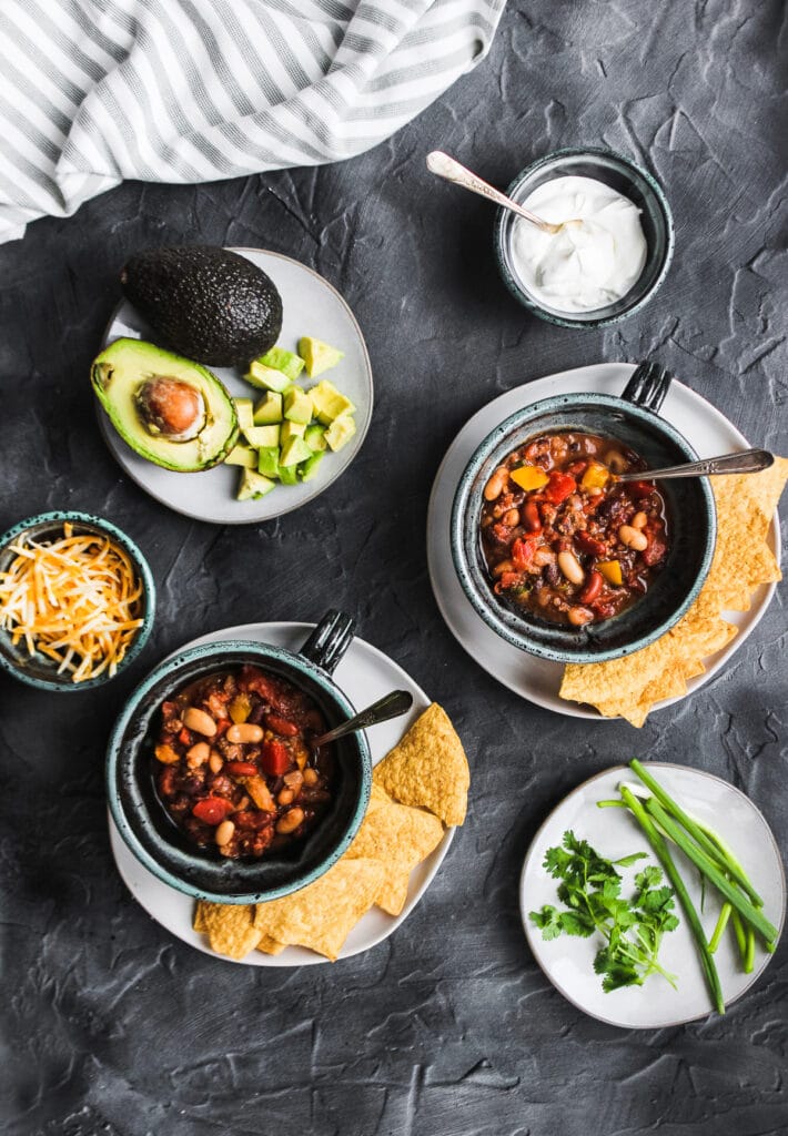 Hearty bowls of the chili with ideas for toppings.