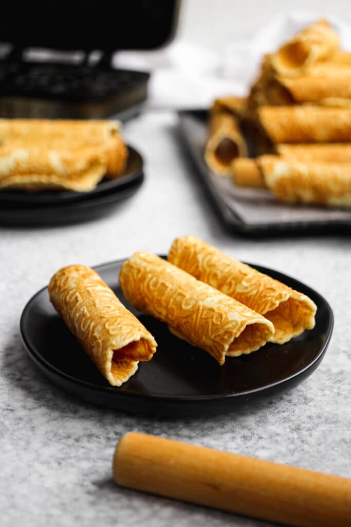 Close view of the rolled Norwegian krumkake cookies.