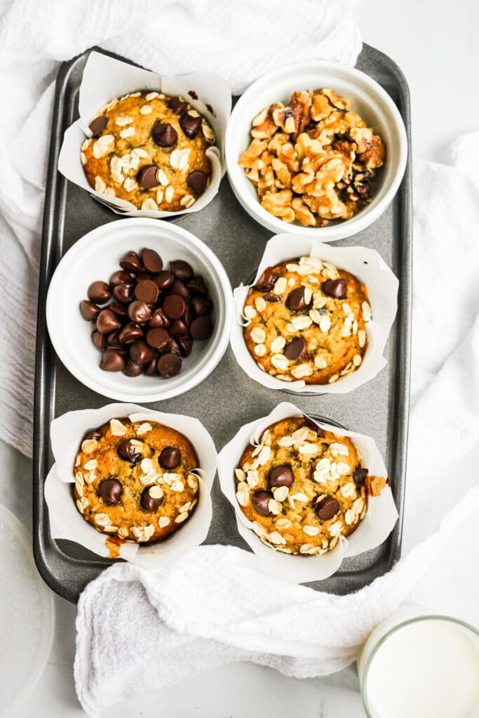 Chocolate and oat topped banana muffins in the muffin tin.