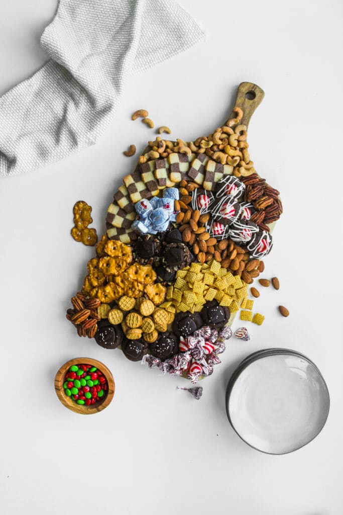 All of the cookies, nuts, and candies on a decadent holiday dessert board.