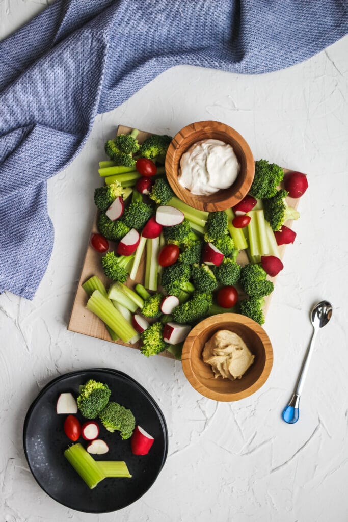 Veggie board with hummus and sour cream dip.