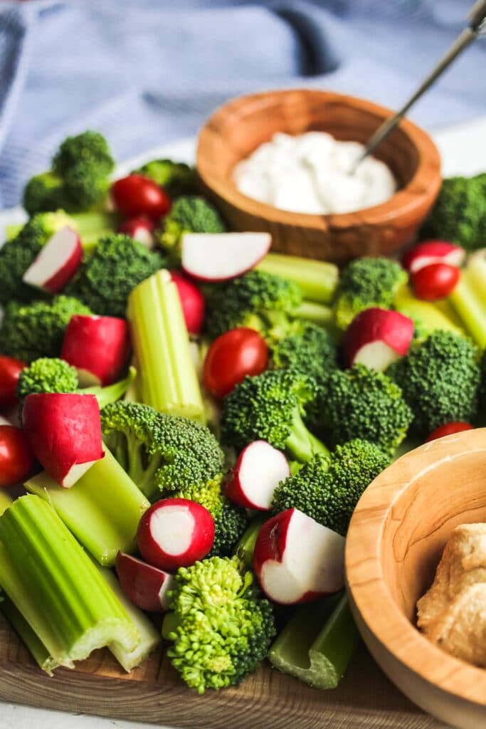 Close view of celery sticks, radishes, and broccoli. 