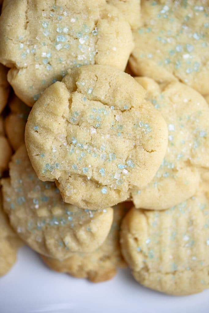 Close up of sugar cookies with blue sprinkles.