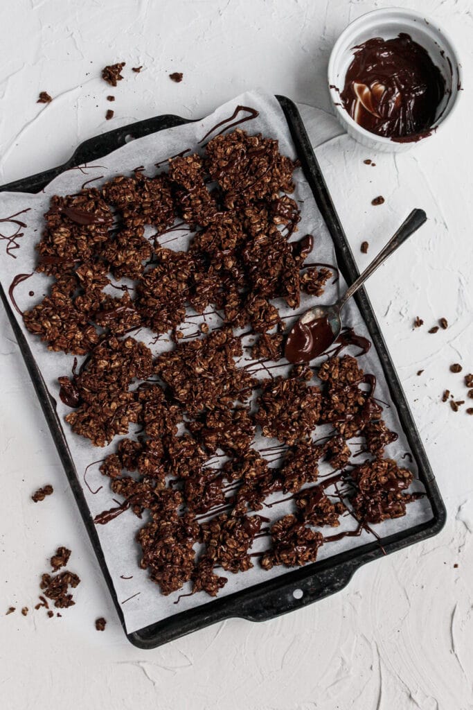 Tray of granola with a chocolate drizzle.