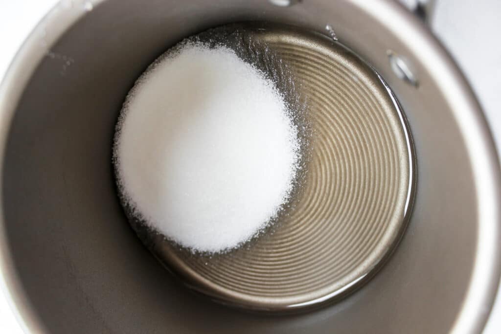 Corn syrup and sugar in a saucepan before heating.