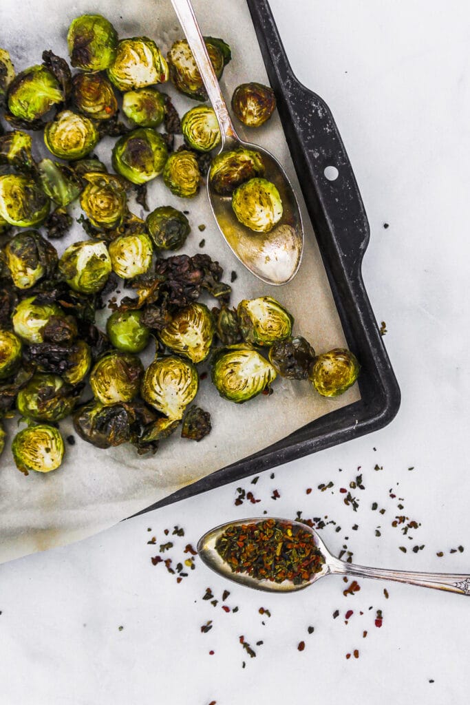 Easy oven roasted brussels sprouts with seasoning on a spoon.