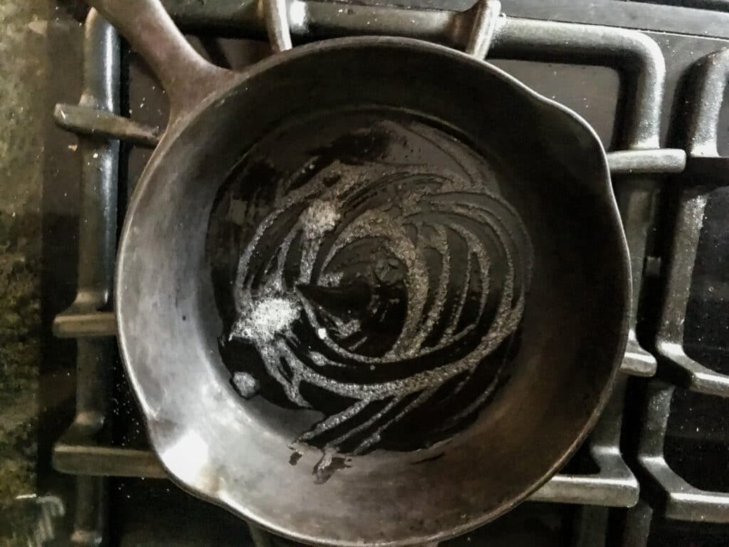 Buttered cast iron skillet on the stove.