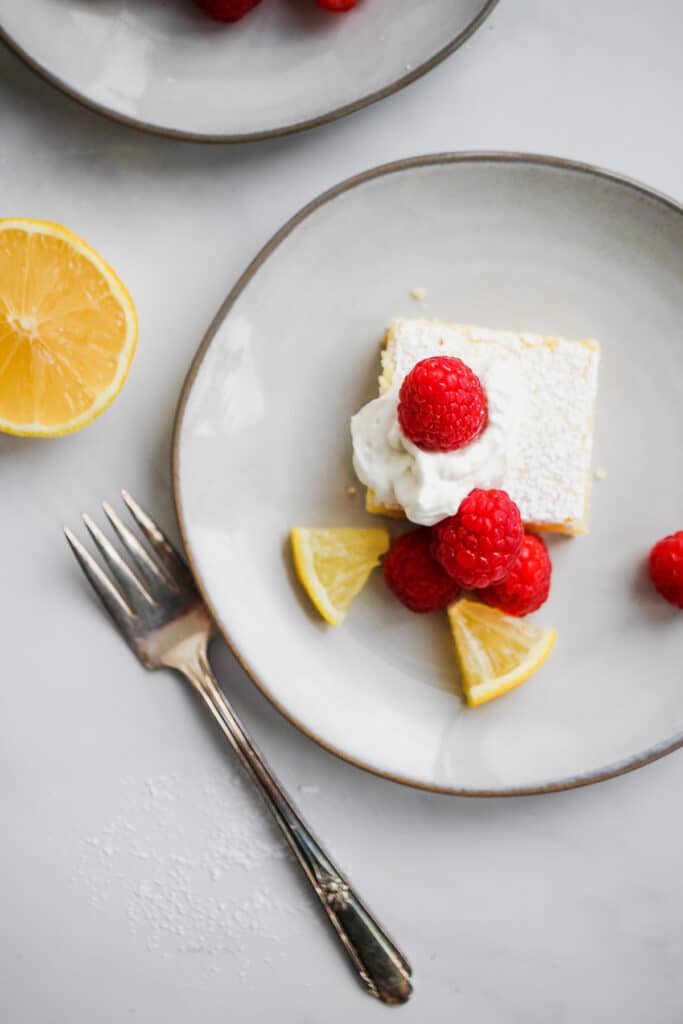 Overhead shot of lemon bar with raspberries.