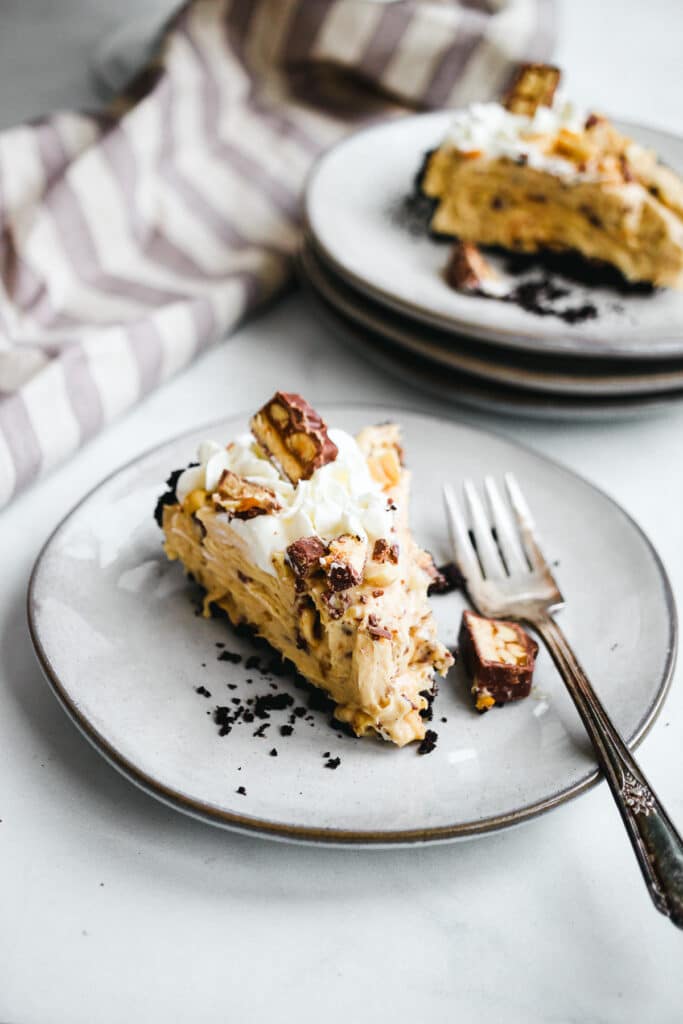 Slice of no bake Snickers pie.