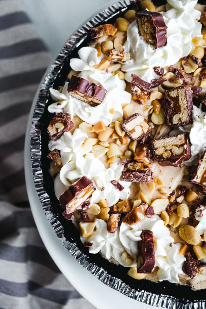 Overhead of Snickers pie toppings.