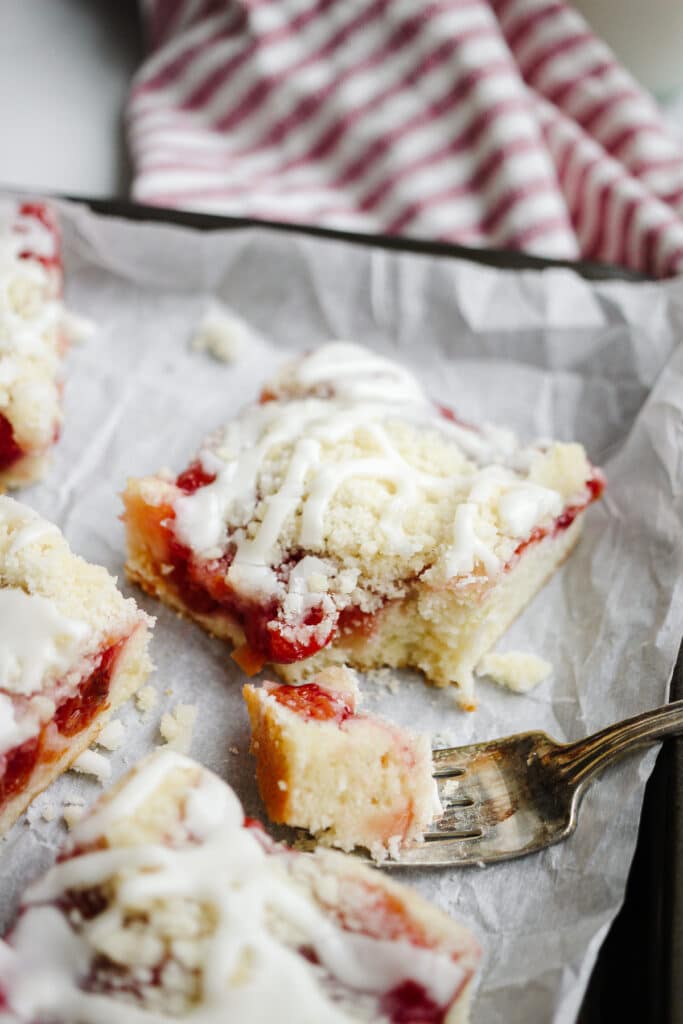 Bite shot of a slice of cherry streusel almond coffeecake. 