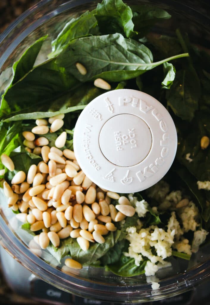 Ingredients for homemade classic pesto in the food processor.