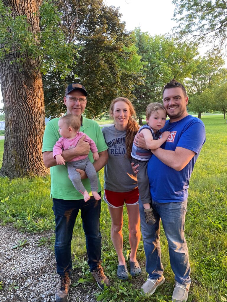 Smiling with Grandpa in the yard.