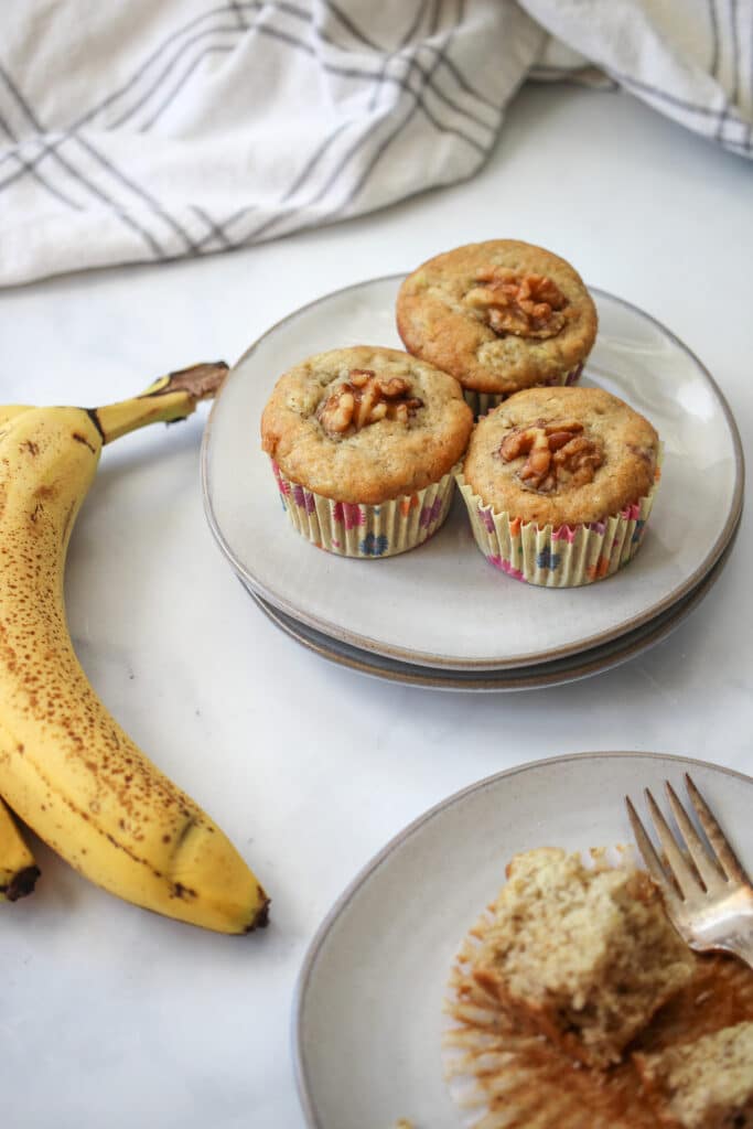 The banana zucchini muffins shown on a plate.