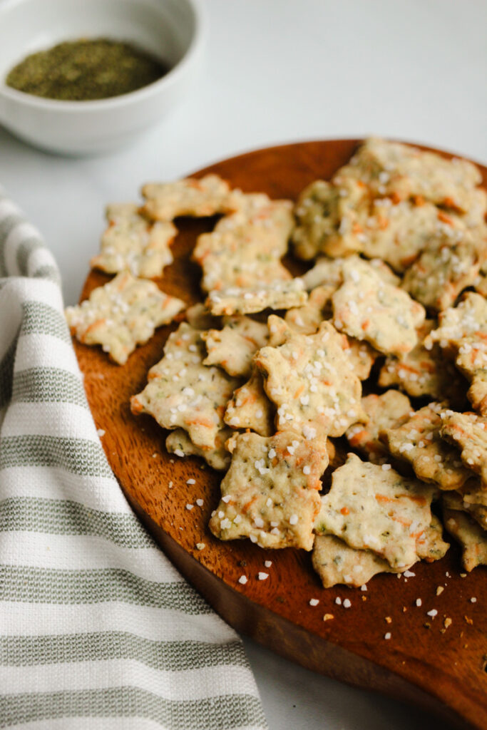 Parmesan herb crackers with sourdough discard on a wooden tray.