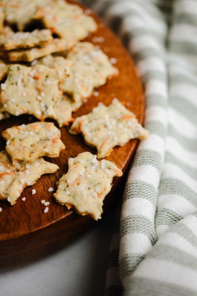 Parmesan herb crackers with sourdough discard on a wooden tray.